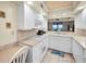 Well-equipped kitchen features white cabinets and stainless appliances at 1340 Gulf Blvd # 8C, Clearwater Beach, FL 33767