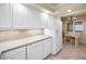 Bright kitchen featuring ample white cabinets and a dining area with a window, creating a cozy atmosphere at 1340 Gulf Blvd # 8C, Clearwater Beach, FL 33767