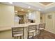 Open-concept kitchen with bar seating offering a view of the adjacent dining and living spaces at 1340 Gulf Blvd # 8C, Clearwater Beach, FL 33767
