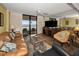 Bright living room with comfortable seating, and a large sliding glass door that leads to the balcony at 1340 Gulf Blvd # 8C, Clearwater Beach, FL 33767