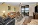 Relaxing living room with neutral toned furniture and sliding glass doors that open to the balcony at 1340 Gulf Blvd # 8C, Clearwater Beach, FL 33767