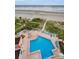 Stunning aerial view of the community pool and manicured grounds near the beach at 1340 Gulf Blvd # 8C, Clearwater Beach, FL 33767