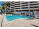 Community pool with palm trees, beach access and building views at 1340 Gulf Blvd # 8C, Clearwater Beach, FL 33767