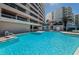 Community pool with beach access, lounge chairs and building views at 1340 Gulf Blvd # 8C, Clearwater Beach, FL 33767