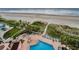 Aerial view of pool deck featuring a pool, hot tub, lounge chairs and ocean view at 1340 Gulf Blvd # 8C, Clearwater Beach, FL 33767