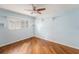 Bedroom featuring wood-look floors, neutral walls, plantation shutters and a ceiling fan at 1517 60Th S St, Gulfport, FL 33707