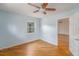 Cozy bedroom with light blue walls, wood flooring, ceiling fan, and open door, offering a welcoming ambiance at 1517 60Th S St, Gulfport, FL 33707