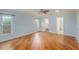 Bedroom featuring wood-look floors, neutral walls, a ceiling fan, and walk-in closet at 1517 60Th S St, Gulfport, FL 33707