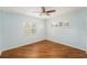 Bedroom with wood-look floors, neutral walls, plantation shutters and a ceiling fan at 1517 60Th S St, Gulfport, FL 33707