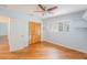 Bright bedroom with light blue walls, wooden floors, closet, ceiling fan and window offering natural light at 1517 60Th S St, Gulfport, FL 33707