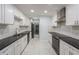 Modern kitchen with white cabinets, stainless steel appliances, and luxurious marble floors at 1517 60Th S St, Gulfport, FL 33707