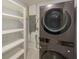 This laundry room has a stacked washer/dryer and ample shelving at 1517 60Th S St, Gulfport, FL 33707