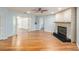 Spacious living room with wood floors, a stone fireplace, and built-in shelves at 1517 60Th S St, Gulfport, FL 33707