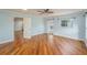 Spacious living room with wood-look floors, a ceiling fan, and an open doorway at 1517 60Th S St, Gulfport, FL 33707