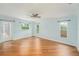 Bright living room with a ceiling fan, three windows, and wood-look flooring at 1517 60Th S St, Gulfport, FL 33707
