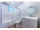 Modern bathroom featuring vanity with decorative mirror, tub, and updated fixtures at 1700 Shore Acres Ne Blvd, St Petersburg, FL 33703