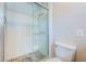 Modern bathroom features a tiled shower with decorative stone floor and glass door at 1700 Shore Acres Ne Blvd, St Petersburg, FL 33703