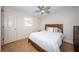 Bedroom featuring a ceiling fan, wood-look floors, and natural light from the window at 1700 Shore Acres Ne Blvd, St Petersburg, FL 33703