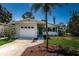 Charming single-story home featuring a white brick facade, blue door, and well-maintained landscaping at 1700 Shore Acres Ne Blvd, St Petersburg, FL 33703