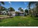 Well-manicured front yard and landscaping highlight this charming single-story home with a white brick facade at 1700 Shore Acres Ne Blvd, St Petersburg, FL 33703