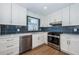 Well-lit kitchen with stainless steel appliances, white cabinetry, and updated fixtures at 1700 Shore Acres Ne Blvd, St Petersburg, FL 33703