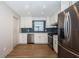 Modern kitchen with stainless steel appliances, white cabinetry, and stylish backsplash at 1700 Shore Acres Ne Blvd, St Petersburg, FL 33703