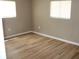 Bright bedroom with hardwood floors and natural light from two large windows at 208 Wilson Ave, Brooksville, FL 34601