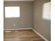 Bright bedroom with wood flooring and natural light from two windows at 208 Wilson Ave, Brooksville, FL 34601