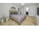 Stylish bedroom with gray accents, a modern side table, and ensuite bathroom at 2121 Dodge St, Clearwater, FL 33760
