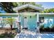 Close up of front entrance with white door, stone accents and fresh landscaping at 2121 Dodge St, Clearwater, FL 33760