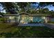 Charming single-story home with a well-manicured front lawn and inviting stone-accented entrance at 2121 Dodge St, Clearwater, FL 33760