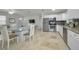 The open floor plan kitchen features stainless steel appliances and adjacent dining area at 2121 Dodge St, Clearwater, FL 33760