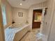 Bathroom featuring tiled floors, large tub, and view of vanity with wood cabinets at 2210 Bayou Dr, Holiday, FL 34691