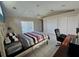 Bright bedroom with neutral walls and tiled floor, featuring a ceiling fan and sliding glass door at 2210 Bayou Dr, Holiday, FL 34691