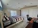 Bright bedroom with neutral walls and tiled floor, featuring a ceiling fan and sliding glass door at 2210 Bayou Dr, Holiday, FL 34691