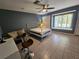 Spacious bedroom with tile flooring, a comfortable sitting area, and a window with a view at 2210 Bayou Dr, Holiday, FL 34691