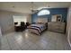 Spacious bedroom featuring tile floors, a desk with monitors, and blue accent wall at 2210 Bayou Dr, Holiday, FL 34691