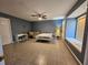Bedroom offers a spacious interior with blue walls, a window seat, and a white metal bed frame at 2210 Bayou Dr, Holiday, FL 34691
