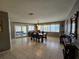Dining room with a view of the backyard through large windows at 2210 Bayou Dr, Holiday, FL 34691