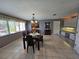 Open dining room with natural light, tile flooring, and a view of the backyard at 2210 Bayou Dr, Holiday, FL 34691