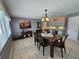 Open dining room with tile floors, a glass table, and recessed lighting at 2210 Bayou Dr, Holiday, FL 34691