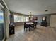 Dining area with plenty of natural light and a view of the screened patio at 2210 Bayou Dr, Holiday, FL 34691