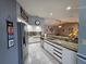 Kitchen featuring stainless appliances, tile floors, granite counters, and an open-concept design at 2210 Bayou Dr, Holiday, FL 34691