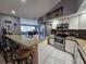 Bright kitchen with granite counters, stainless steel appliances, and breakfast bar at 2210 Bayou Dr, Holiday, FL 34691