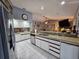 Spacious kitchen with stainless steel appliances, white cabinets, and an adjoining living space at 2210 Bayou Dr, Holiday, FL 34691