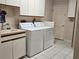 Well-equipped laundry room with sink, washer, and dryer for convenience at 2210 Bayou Dr, Holiday, FL 34691