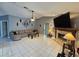 Cozy living room with fireplace, TV, ceiling fan, and tile flooring at 2210 Bayou Dr, Holiday, FL 34691