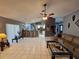 Open-concept living room with tile flooring seamlessly connecting to the kitchen bar, perfect for modern living at 2210 Bayou Dr, Holiday, FL 34691