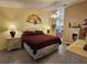 Well-lit main bedroom with neutral walls, tiled floors, and a large ceiling fan at 2210 Bayou Dr, Holiday, FL 34691