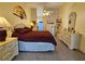 Comfortable main bedroom boasting tiled floors, bright lighting, and a ceiling fan at 2210 Bayou Dr, Holiday, FL 34691